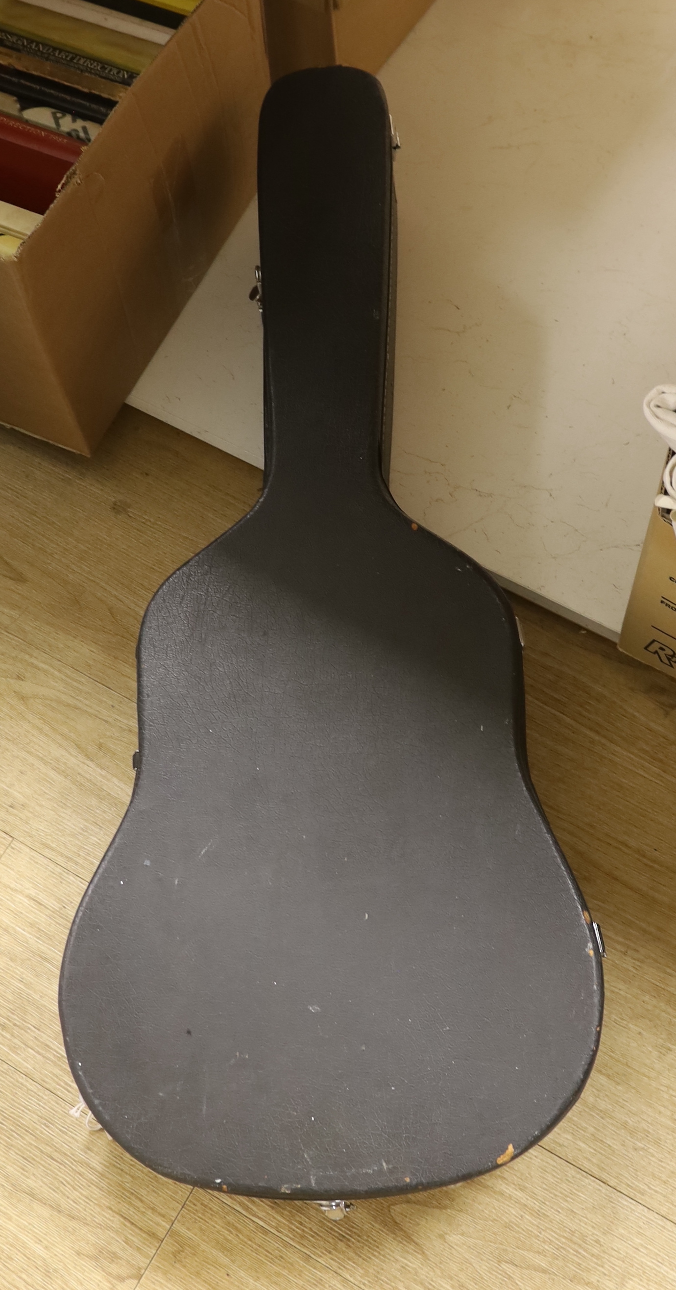 A Fender acoustic left handed guitar, in a hard case